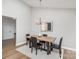 Modern dining room with a stylish chandelier, sleek chairs and an area rug at 5843 Timber Falls Nw Pl, Concord, NC 28027