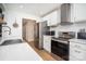 Bright kitchen with stainless steel appliances, sleek white cabinets, and quartz countertops at 5843 Timber Falls Nw Pl, Concord, NC 28027