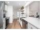 Bright kitchen features stainless appliances, white cabinetry, and open shelving at 5843 Timber Falls Nw Pl, Concord, NC 28027