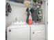 A dedicated laundry room featuring a white washer and dryer with wire rack storage at 5843 Timber Falls Nw Pl, Concord, NC 28027