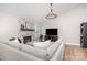 Spacious living room featuring a cozy fireplace, modern decor, and hardwood floors at 5843 Timber Falls Nw Pl, Concord, NC 28027