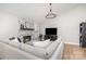 Spacious living room featuring a cozy fireplace, modern decor, and hardwood floors at 5843 Timber Falls Nw Pl, Concord, NC 28027