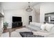 Comfortable living room with a stone fireplace, plush seating, and hardwood floors at 5843 Timber Falls Nw Pl, Concord, NC 28027