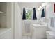 Well-lit bathroom featuring a white vanity, a window providing natural light, and a shower with a curtain at 81 21St Nw Ave, Hickory, NC 28601
