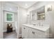 Bright bathroom features a double vanity with quartz countertop, stylish mirror, and decorative lighting at 81 21St Nw Ave, Hickory, NC 28601