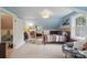 Charming bedroom featuring blue ceiling, a cozy rocking chair, and natural light from the window at 81 21St Nw Ave, Hickory, NC 28601