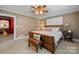 Comfortable bedroom featuring a ceiling fan, a wooden bed frame and a bench with a woven basket underneath at 81 21St Nw Ave, Hickory, NC 28601