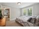 Inviting bedroom featuring two bright windows, a comfortable bed, and a glimpse of another room for expanded living at 81 21St Nw Ave, Hickory, NC 28601
