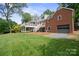 Charming brick home with a two-story deck, attached garage, and well-maintained lawn, perfect for outdoor enjoyment at 81 21St Nw Ave, Hickory, NC 28601