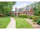 Brick home with a manicured lawn and landscaped path, showcasing classic architecture and curb appeal at 81 21St Nw Ave, Hickory, NC 28601