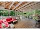 Relax on the screened porch, featuring a cozy seating area, ceiling fan, and exposed-beam ceiling at 81 21St Nw Ave, Hickory, NC 28601
