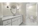 Bright bathroom with white vanity, marble countertop, and decorative lighting at 8500 Headford Rd, Charlotte, NC 28277