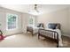 Neutral bedroom with windows, ceiling fan, and two twin beds at 8500 Headford Rd, Charlotte, NC 28277