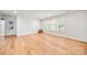 Large bonus room showcasing hardwood flooring and natural light from shuttered windows at 8500 Headford Rd, Charlotte, NC 28277