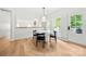 Cozy breakfast nook with wood floors and access to the outdoor deck through a white door and shuttered windows at 8500 Headford Rd, Charlotte, NC 28277