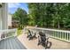 Spacious deck with wood chairs overlooking a lush, green backyard with mature trees and play equipment at 8500 Headford Rd, Charlotte, NC 28277