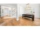 Light-filled dining room with a modern chandelier, bench seating, and wood floors at 8500 Headford Rd, Charlotte, NC 28277