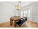Light-filled dining room with a modern chandelier, bench seating, and wood floors at 8500 Headford Rd, Charlotte, NC 28277