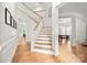 Bright foyer featuring white walls, a staircase, wood floors, and decorative trim at 8500 Headford Rd, Charlotte, NC 28277