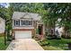 Stately two-story brick home with a landscaped front yard, driveway, and a two car garage at 8500 Headford Rd, Charlotte, NC 28277
