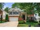 Stately two-story brick home with a landscaped front yard, driveway, and a two car garage at 8500 Headford Rd, Charlotte, NC 28277