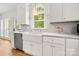 Bright kitchen featuring a farmhouse sink, stainless steel dishwasher, and marble countertops at 8500 Headford Rd, Charlotte, NC 28277