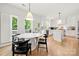 Bright eat-in kitchen featuring wood floors, white cabinetry, and a light-filled breakfast area with doors to a deck at 8500 Headford Rd, Charlotte, NC 28277