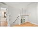 Upstairs landing featuring hardwood floors, natural light, and an open railing at 8500 Headford Rd, Charlotte, NC 28277