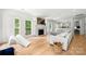 Open-concept living space with fireplace, light-filled windows, and hardwood floors at 8500 Headford Rd, Charlotte, NC 28277