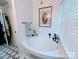 Bathroom featuring a white bathtub, black fixtures, and black and white flooring at 101 Sunset Dr, Stanley, NC 28164