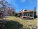 Charming home with a cozy front porch, manicured landscaping, and patriotic American flag display at 101 Sunset Dr, Stanley, NC 28164