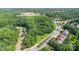 Aerial view of a home near the highway and neighborhood surrounded by lush trees at 10105 Community House Rd, Charlotte, NC 28277