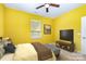 Well-lit bedroom features carpeted floors, ceiling fan, and a TV for relaxing and entertainment at 10105 Community House Rd, Charlotte, NC 28277