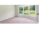 A sunlit bedroom boasts a bay window providing lots of light and green views at 1016 S D Ave, Maiden, NC 28650
