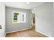 A neutrally decorated bedroom with light gray walls and wood-look flooring connects to another room at 1016 S D Ave, Maiden, NC 28650