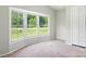 A light filled bedroom features a bay window providing lots of light and closet storage at 1016 S D Ave, Maiden, NC 28650