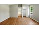 A bright bedroom with light gray walls, wood-look flooring, and a closet provides lots of storage at 1016 S D Ave, Maiden, NC 28650