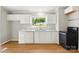 Bright kitchen features white cabinets, countertops, and black appliances at 1016 S D Ave, Maiden, NC 28650