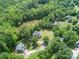 Aerial view of home on large lot with mature trees and stream at 1062 Willow Ridge Ln, Fort Mill, SC 29707