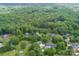 Aerial view of beautiful home surrounded by mature trees and a stream at 1062 Willow Ridge Ln, Fort Mill, SC 29707