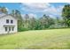 Spacious backyard with mature trees and a home with white siding at 1062 Willow Ridge Ln, Fort Mill, SC 29707