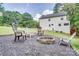 Backyard fire pit surrounded by chairs and black gravel, perfect for outdoor entertaining and relaxation at 1062 Willow Ridge Ln, Fort Mill, SC 29707