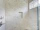 Close up on shower with marble tile, a niche, and a built-in bench at 1062 Willow Ridge Ln, Fort Mill, SC 29707