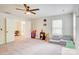 Spacious bedroom with ceiling fan, neutral paint, two open doorways, and lots of toys at 1062 Willow Ridge Ln, Fort Mill, SC 29707