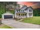 Charming two-story farmhouse with inviting front porch, detached garage and basketball hoop at 1062 Willow Ridge Ln, Fort Mill, SC 29707