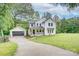 Exterior view of home with attached garage, front porch, and large manicured lawn at 1062 Willow Ridge Ln, Fort Mill, SC 29707