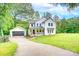 Charming two-story home with a welcoming front porch, detached garage, and a spacious, well-manicured lawn at 1062 Willow Ridge Ln, Fort Mill, SC 29707