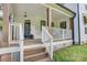 Inviting front porch with wooden steps, white railings, and the house number displayed on a pillar at 1062 Willow Ridge Ln, Fort Mill, SC 29707