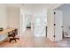 Hallway with natural lighting, beautiful flooring, and views into multiple bedrooms at 1062 Willow Ridge Ln, Fort Mill, SC 29707
