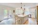 Kitchen with white cabinets, a large island, stainless steel appliances, and a dining area with an outdoor deck at 1062 Willow Ridge Ln, Fort Mill, SC 29707